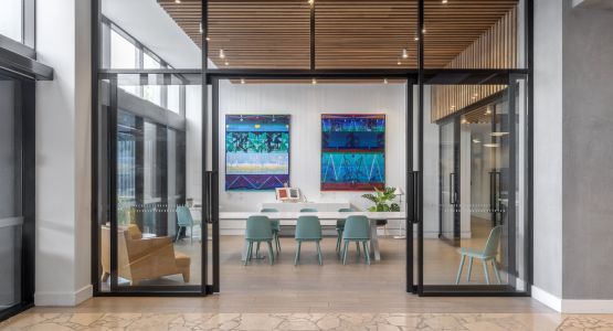 Open doors to a meeting space with art work on the walls